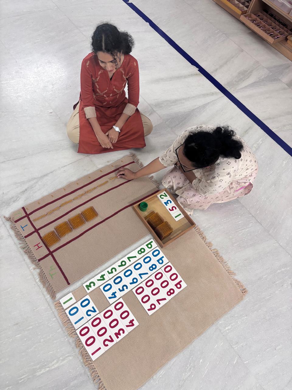 FTTA trainee arranging long rods and number cards during Montessori math practice